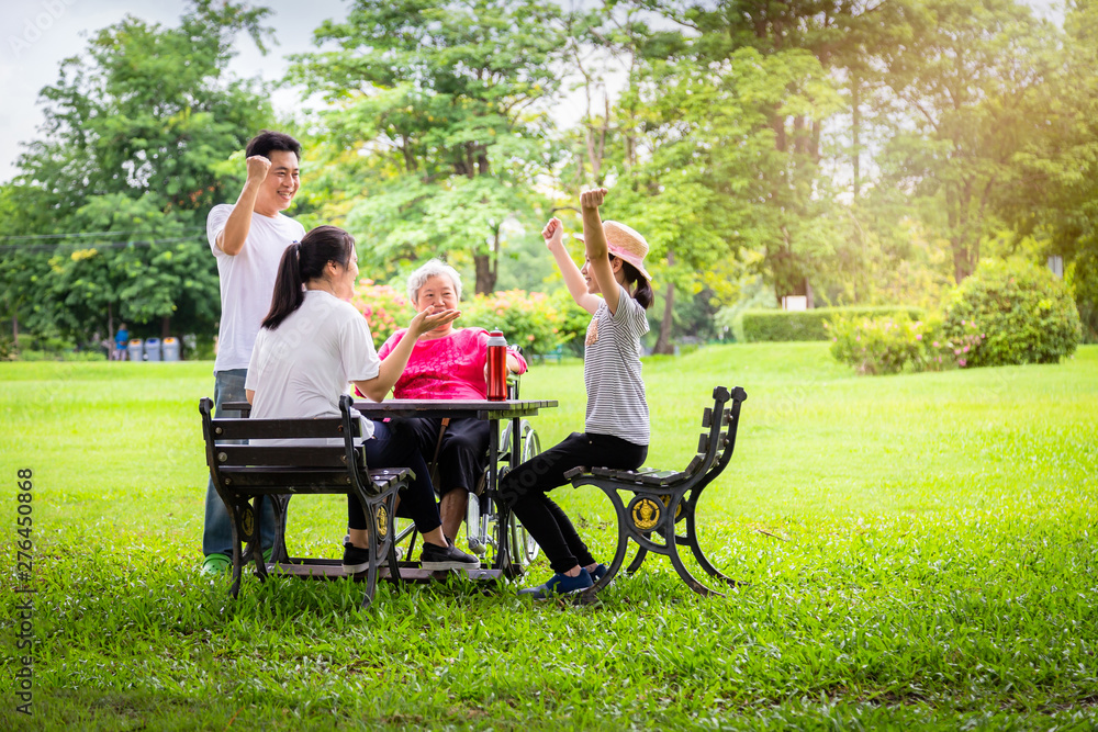Happy asian family in outdoor park,father,mother with little child girl or daughter play,dancing,elderly having fun,laugh,smile together,senior grandmother in wheelchair with her family in nature Happy asian family in outdoor park,father,mother with little child girl or daughter play,dancing,elderly having fun,laugh,smile together,senior grandmother in wheelchair with her family in nature