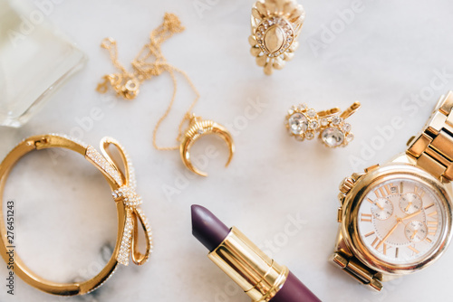 A collection of jewelry, watches and makeup