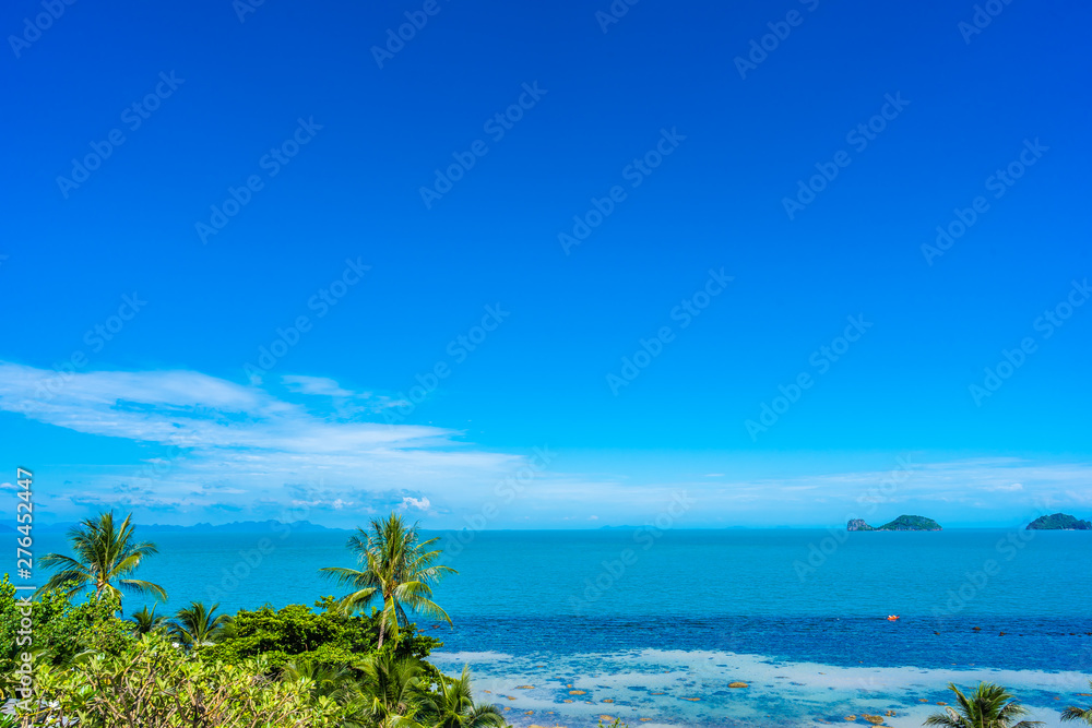 Beautiful tropical sea ocean with coconut palm tree on blue sky white cloud Beautiful tropical sea ocean with coconut palm tree on blue sky white cloud