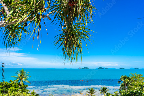 Beautiful tropical sea ocean with coconut palm tree on blue sky white cloud