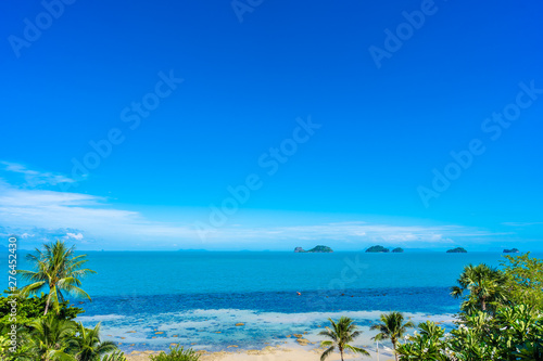 Beautiful tropical sea ocean with coconut palm tree on blue sky white cloud
