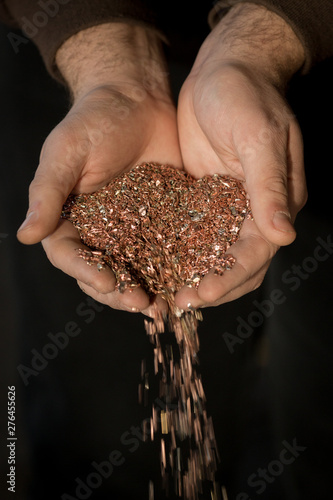 Copper shavings in the hands of the workers.