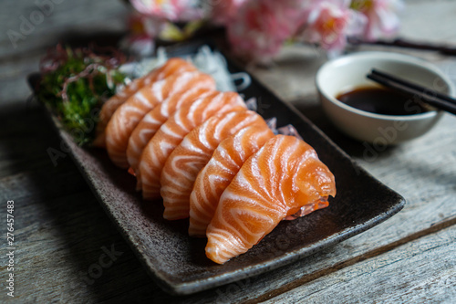 Łososiowe sashimi Japońskie jedzenie z sosem sojowym na drewnianym stole