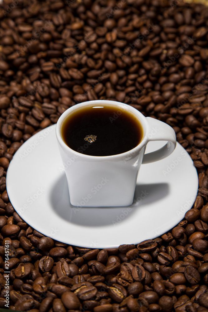 over head lit cup of coffee over head lit cup of coffee