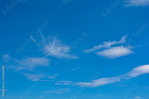 Fluffy white clouds on a blue sky background