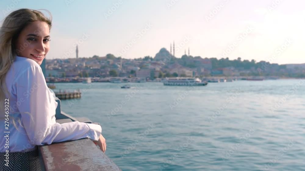 Slow Motion:Beautiful girl stands over Galata Bridge and enjoys view of bosphorus in Istanbul,Turkey.Traveler concept Slow Motion:Beautiful girl stands over Galata Bridge and enjoys view of bosphorus in Istanbul,Turkey.Traveler concept