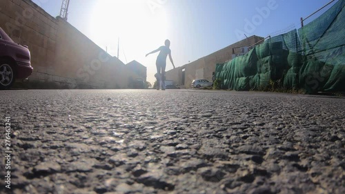 Young woman filming herself with a gopro on the ground in slow motion, gliding over the gorpo, waving her arms up in the air with bright sunshine. photo