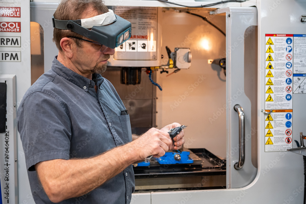 CNC machine operator picking a tool CNC machine operator picking a tool