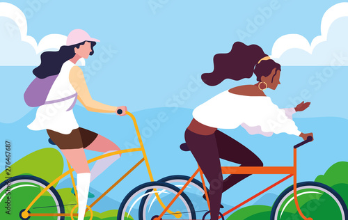 young women riding bike with landscape