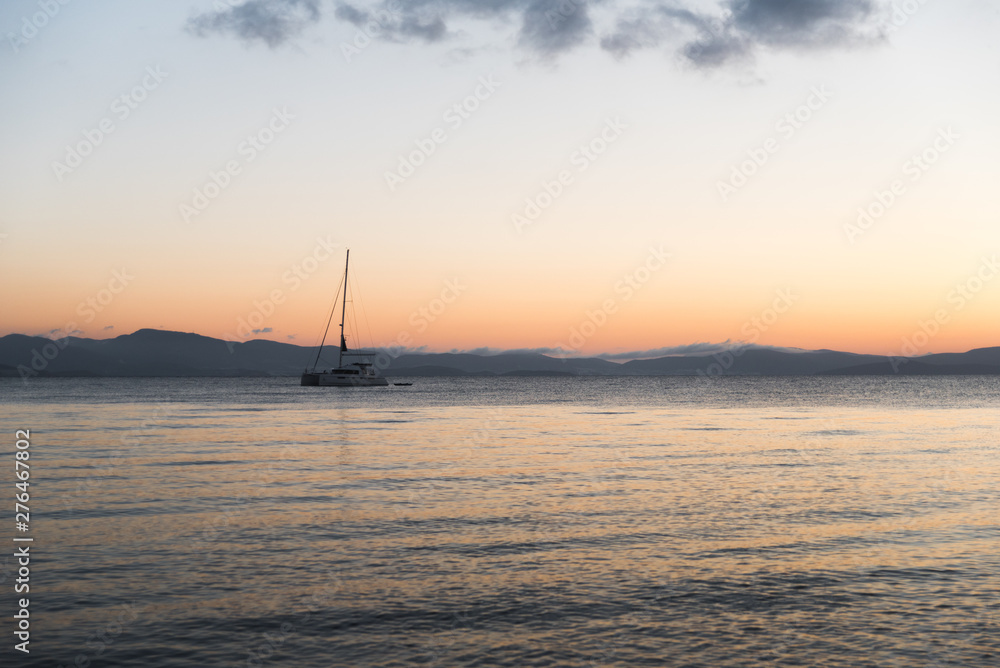 A sail boat on the Aegean Sea during sunrise in Kos, Greece. 