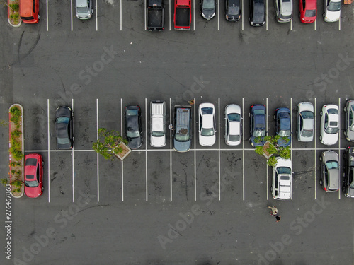фотографія Aerial top view of parking lot at supermarket with with varieties of colored vehicles