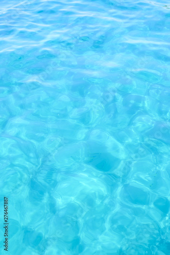 Close-up view of a transparent turquoise sea water that forms a natural texture, Emerald Coast, Sardinia, Italy.