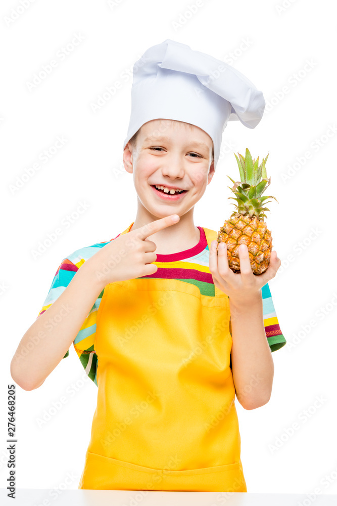 little cook in a cap with a mini pineapple on a white background in an apron