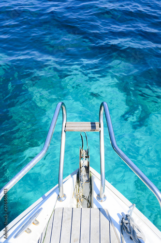 (Selective focus) Stunning view of a bow of a yacht sailing on a beautiful turquoise and transparent sea. Costa Smeralda (Emerald Coast) Sardinia, Italy.  © Travel Wild