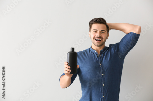 Handsome man with bottle of...