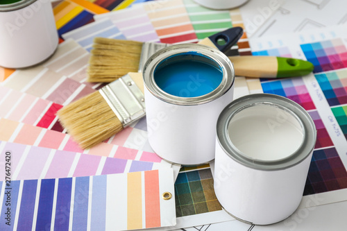 Cans of paint with brushes and palette samples photo