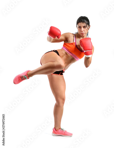 Female kickboxer on white b...