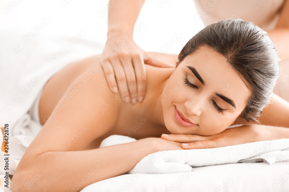 Beautiful young woman receiving massage in spa salon Beautiful young woman receiving massage in spa salon