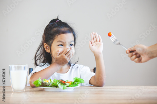 Vászonkép Asian child does not like to eat vegetables and refuse to eat healthy vegetables