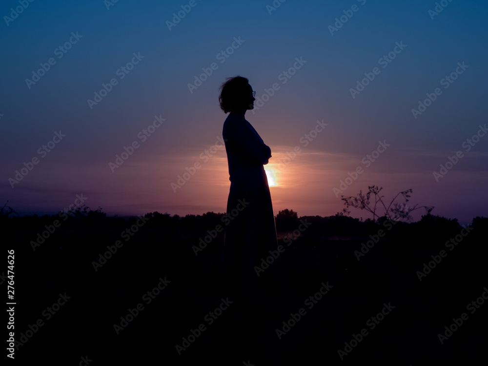 girl standing in the sunset