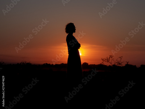 girl standing in the sunset