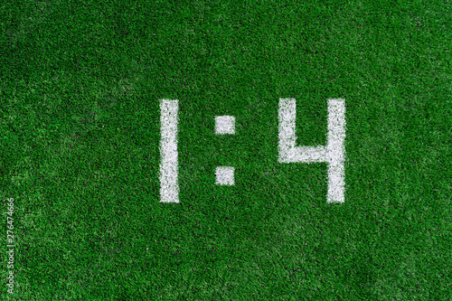 Football score 1 4.White numbers one and four are drawn on the green grass