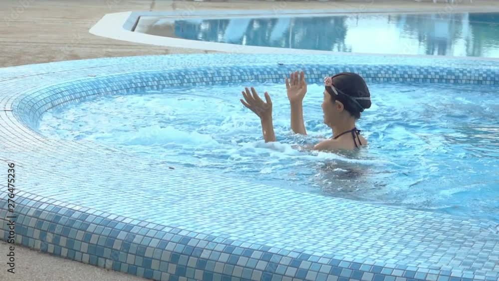 Middle aged woman enjoying in jacuzzi pool . Adult healthy female relax