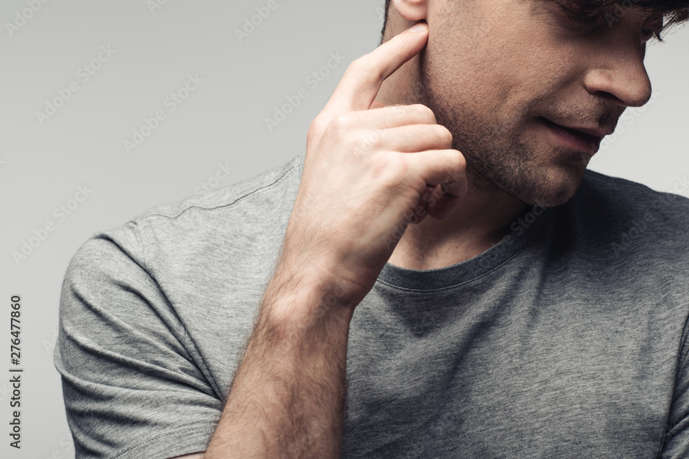 deaf man pointing at ear with finer isolated on grey, human emotion and expression concept deaf man pointing at ear with finer isolated on grey, human emotion and expression concept