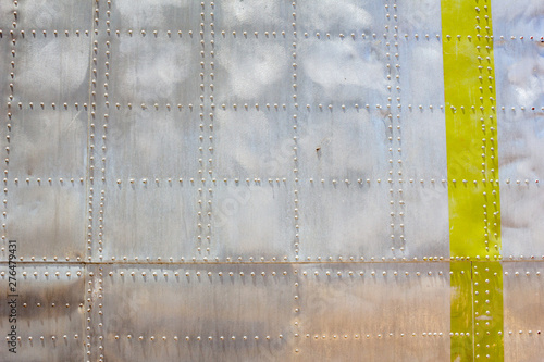 A background of a metallic aircraft body surface