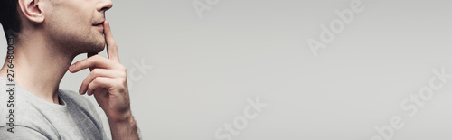 cropped view of dumb man showing quiet sign isolated on grey background, panoramic shot, human emotion and expression concept
