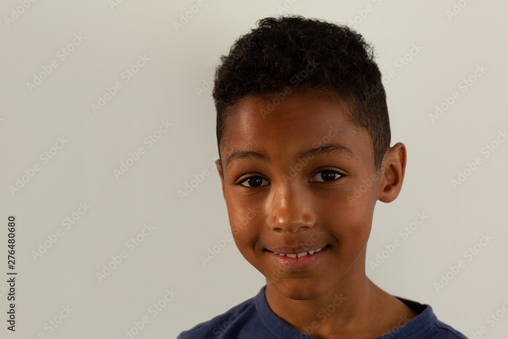 Boy looking at camera against white background Boy looking at camera against white background