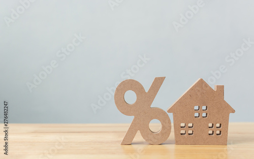 Percentage and house sign symbol icon wooden on wood table with white background photo