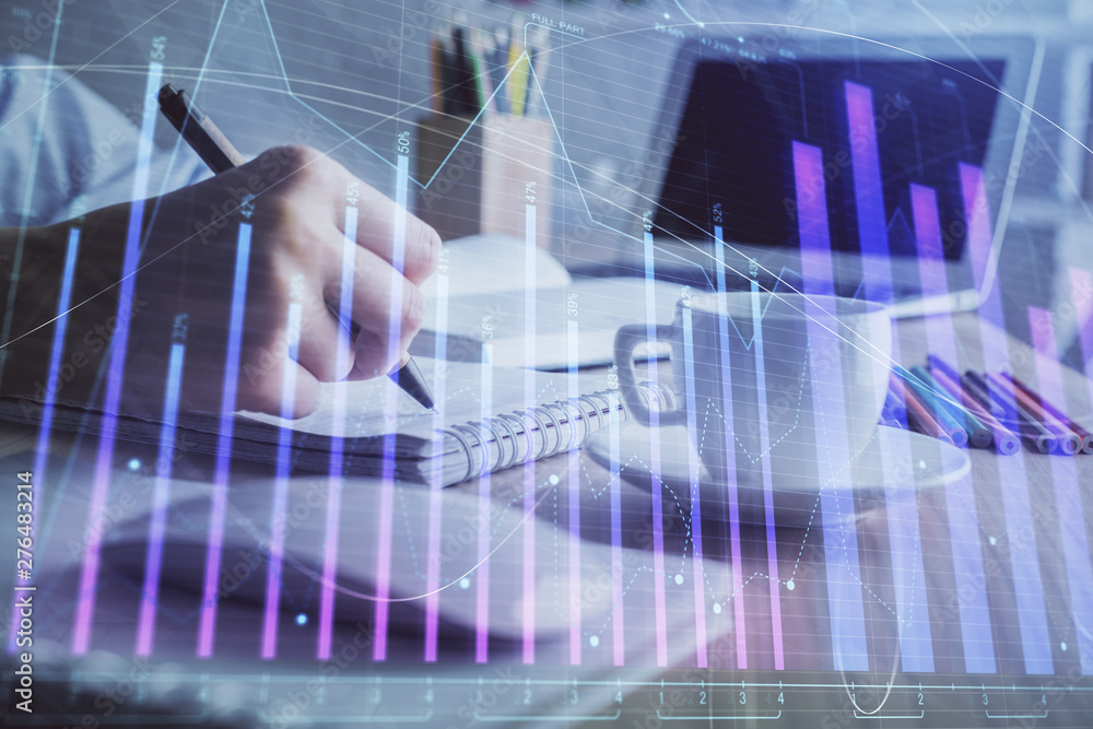 Financial chart drawn over hands taking notes background. Concept of research. Double exposure Financial chart drawn over hands taking notes background. Concept of research. Double exposure