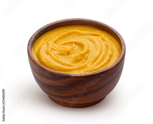 Brown wooden bowl with fruit mush, apple puree