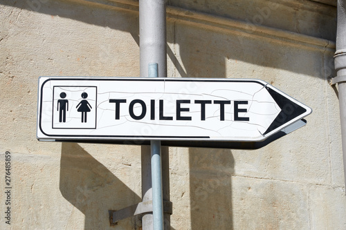 Toilette black and white old sign in a sunny day in France