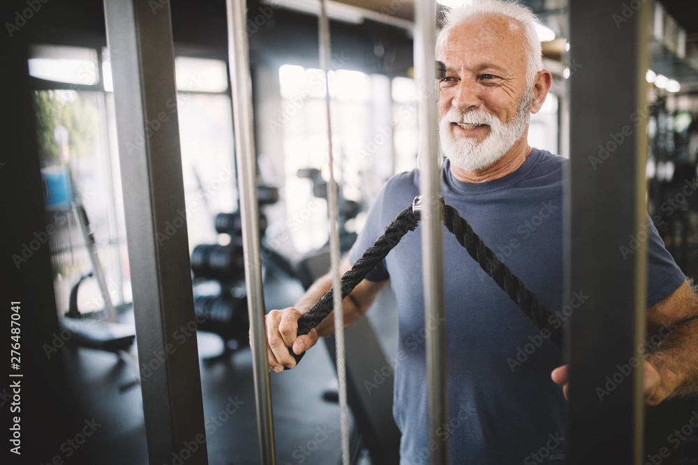 Happy senior people doing exercises in gym to stay fit Happy senior people doing exercises in gym to stay fit