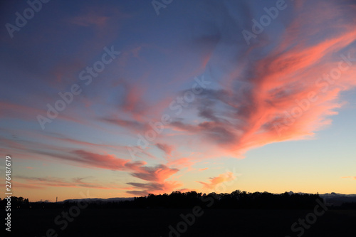 Fototapeta Naklejka Na Ścianę i Meble -  Dramatic sky at a sunset over Hillsboro, Oregon. Red clouds of a strange form like brush stroke of a red color in a blue sky
