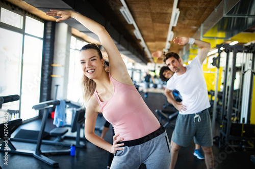 Group of young people doing exercises in gym