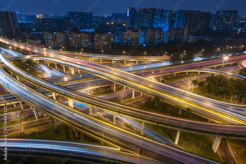Large interchange with busy traffic aerial view at night in Chengdu, China