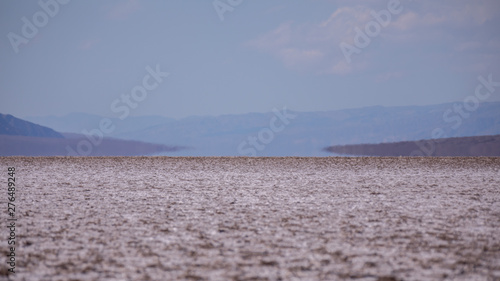 Mirage at a Badwater Basin horizon - heated air rises up from a hot desert surface. The Badwater Basin is an endorheic basin in Death Valley National Park, Death Valley
