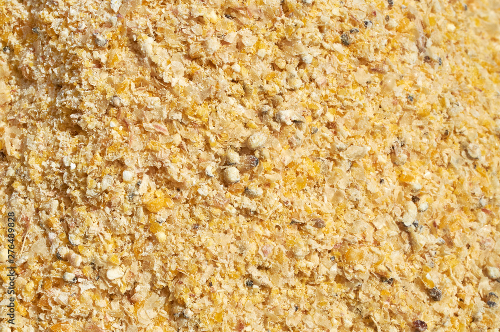 Background texture of crushed seed and grain mix for livestock and bird feed