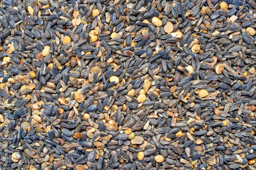 Background texture of crushed seed and grain mix for livestock and bird feed