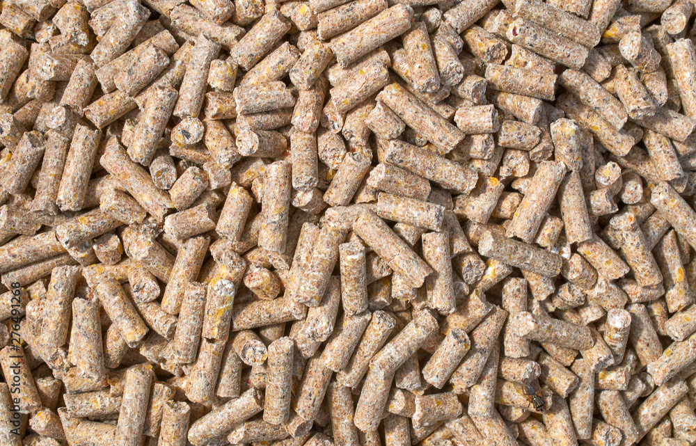 Background texture of crushed seed and grain mix for livestock and bird feed