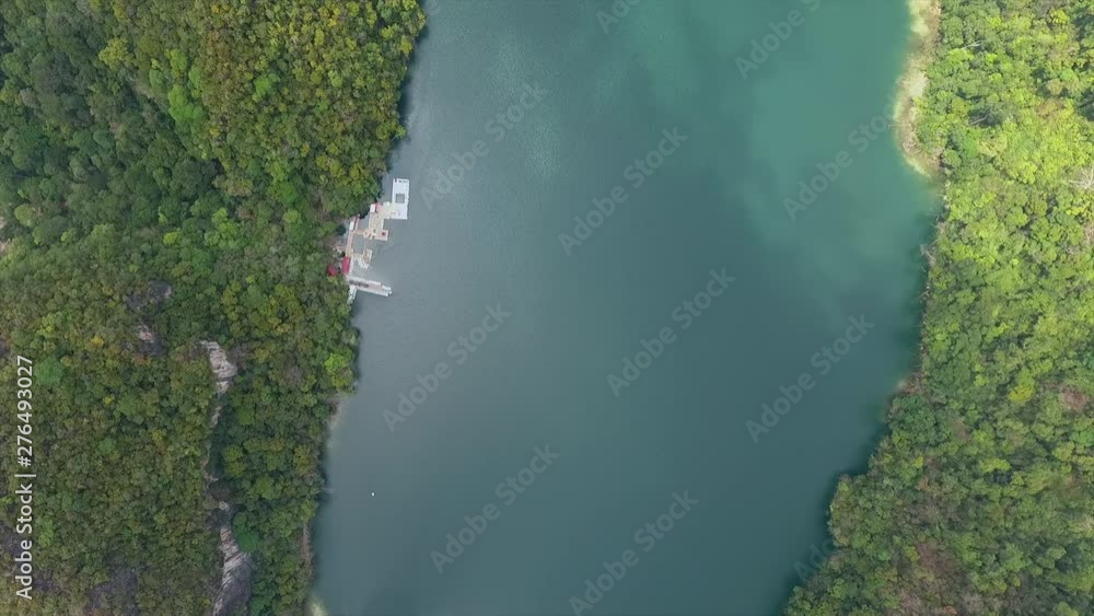 Aerial drone shot of A lagoon surrounded by forests Aerial drone shot of A lagoon surrounded by forests