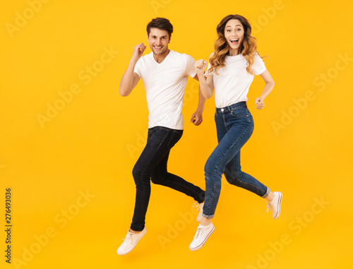 Portrait of athletic couple man and woman smiling at camera while running together