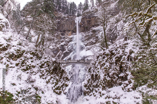 Multnomah Falls, Oregon during winter time. Scenic waterfall in Columbia river gorge covered with white snow photo