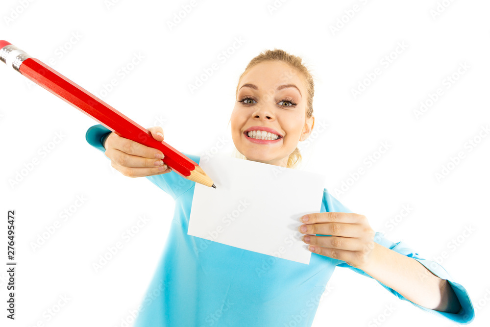 Woman with big pencil writing on paper Woman with big pencil writing on paper