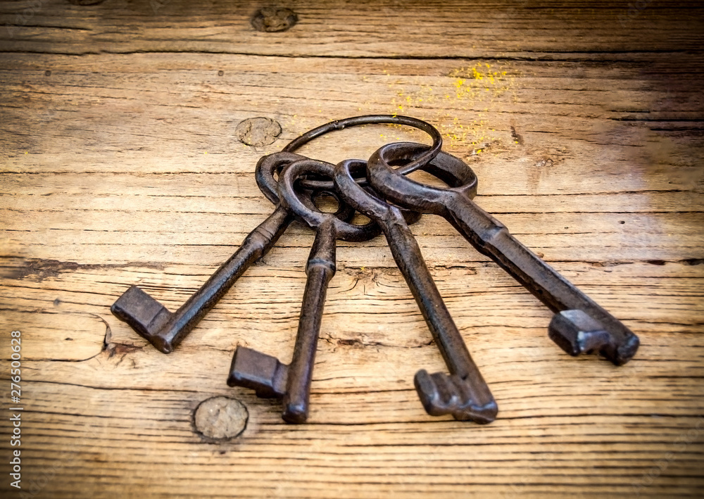 Rusty antique keys on wooden table as background Rusty antique keys on wooden table as background