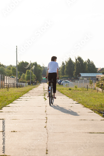 Happy girl rides a classic bike among beautiful nature.