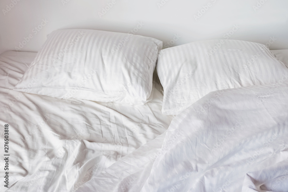Messy bed with white pillows and sheets Messy bed with white pillows and sheets